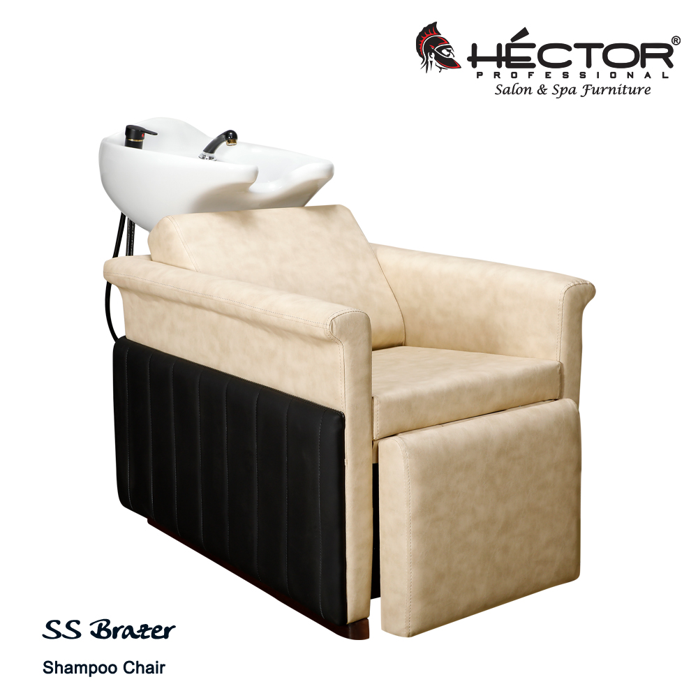 Brazer shampoo station An angled view of the Héctor Professional SS Brazer Shampoo station featuring a cream leatherette seat and integrated leg rest contrasted by black vertically-stitched side panels.