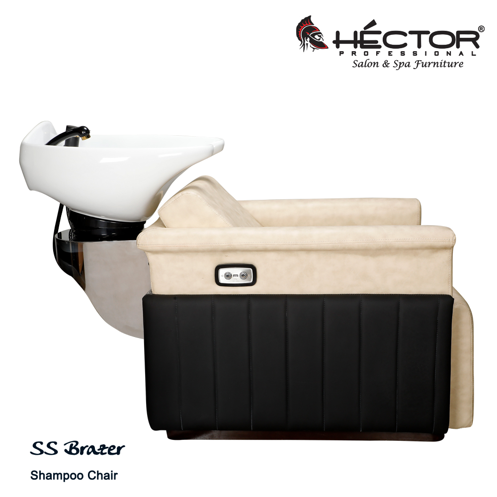 Brazer shampoo station An angled view of the Héctor Professional SS Brazer Shampoo station featuring a plush cream leatherette seat and integrated leg rest contrasted by black vertically-stitched side panels.