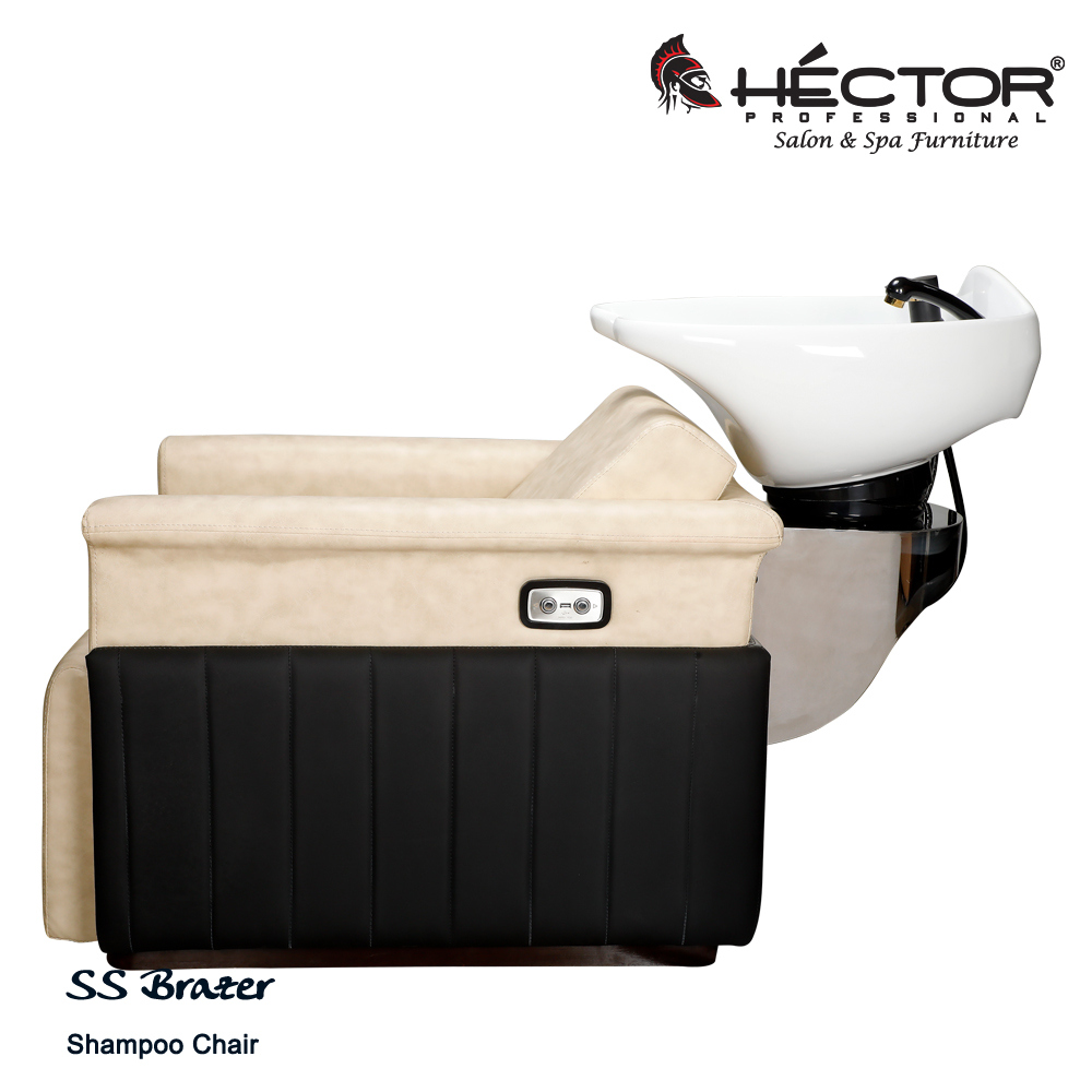 An angled view of the Héctor Professional SS Brazer Shampoo station featuring a plush cream leatherette seat and integrated leg rest, contrasted by black vertically-stitched side panels.