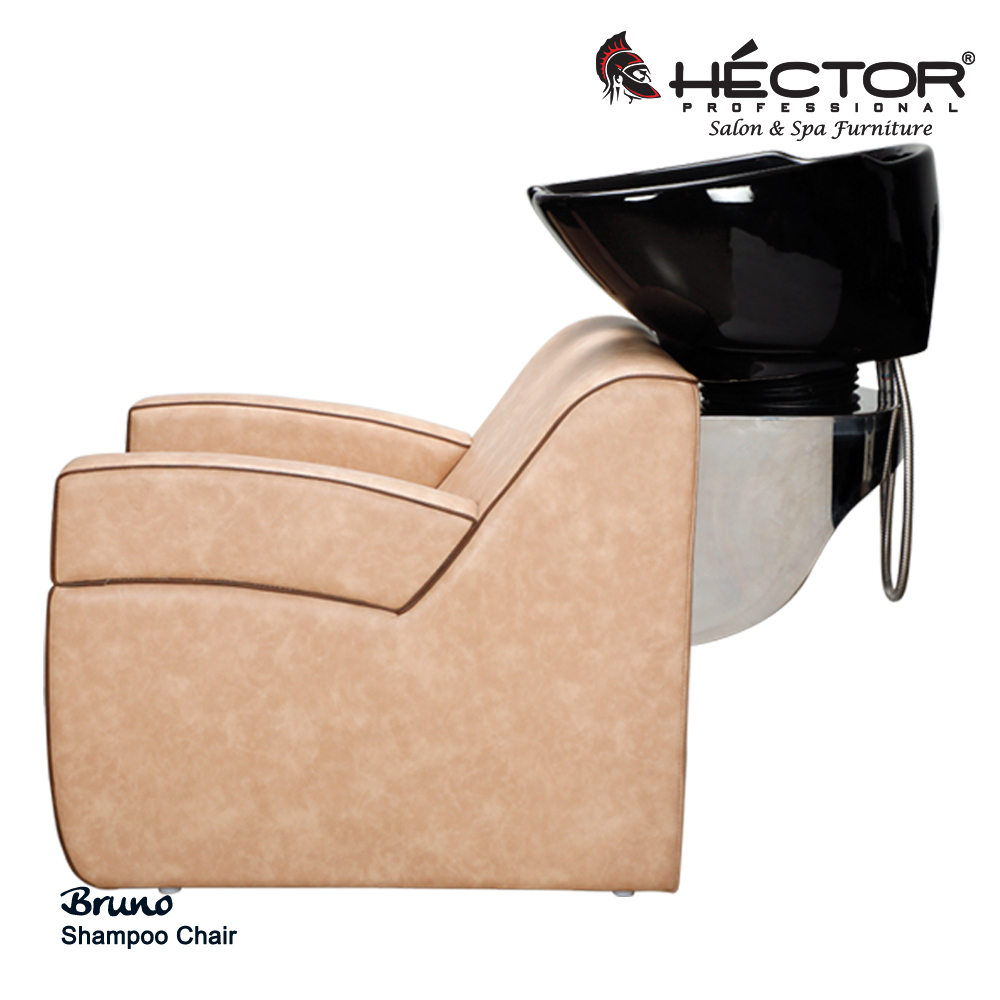 An angled view of the Héctor Professional Bruno Shampoo station showcasing its plush beige leatherette upholstery with contrasting dark brown piping.
